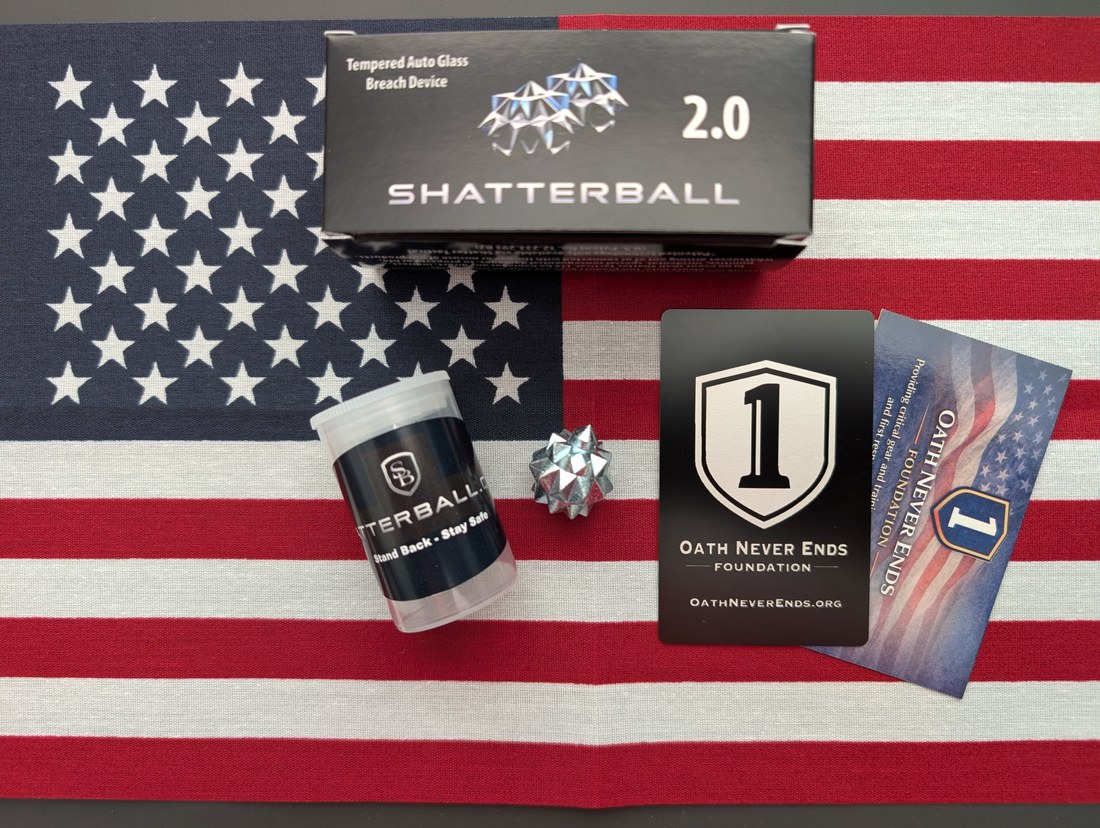 Shatterball 2.0 retail packaging, tube, and spiked ball on American flag